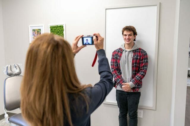 Young man getting his photo taken at dentist office